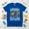 Blue t-shirt with text "We Are All DIFFERENT But In This SCHOOL SWIM TOGETHER," and colorful fish graphic
