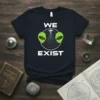 We Exist alien t-shirt design with green alien heads, a UFO, and radar graphics