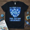 We Wear Blue For Autism Awareness T-Shirt with puzzle pieces, doves, and a brain graphic