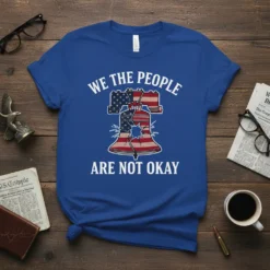 We the People Are Not Okay T-Shirt with cracked Liberty Bell and American flag design, patriotic political statement graphic