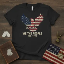 Black t-shirt with "WE THE PEOPLE EST. 1776" text and an eagle graphic with the American flag design