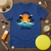 Welcome Summer text with flamingos and palm trees on a blue t-shirt, depicting a beach scene with waves and a