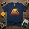 Navy blue t-shirt with "WELCOME TO BEAUTIFUL TIJUANA" text in retro sunset design, featuring palm trees and mountains