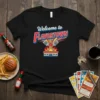 Welcome to Flavortown T-Shirt design featuring bold red and blue lettering with crossed spatulas over a building engulfed in flames