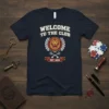 Welcome to the Club Est 2024 text with a lion crest and crossed keys graphic on a navy t-shirt