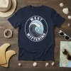 West Wittering Surfing Wave T-Shirt featuring a surfer riding a large wave with "West Wittering" and "West Sussex" text