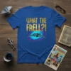 Royal blue t-shirt with "WHAT THE FRELL?!" in gold metallic font and a retro spaceship in a cosmic swirl graphic
