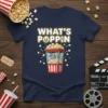 WHAT'S POPPIN text with a cartoon popcorn maker and scattered popcorn pieces on a navy blue t-shirt