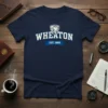 Navy blue t-shirt featuring "WHEATON EST. 1860" in white collegiate lettering with a lion crest above and a blue banner