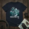 Wheelie Good Time t-shirt with a mountain biker performing a wheelie against a backdrop of mountains and trees