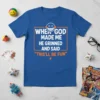 Blue t-shirt with white and orange text reading "When God Made Me He Grinned And Said 'This'll Be Fun'", featuring