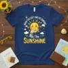 T-shirt with the quote "When You Can't Find The Sunshine Be The Sunshine" featuring a happy sun character holding a