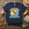When In Doubt Shrimp Out text with a cartoon shrimp surfing a wave on a navy blue t-shirt design