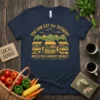 Navy blue t-shirt with "YOU CAN EAT the SCENERY WHITEFISH FARMERS MARKET" text and a graphic of a farmers market