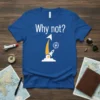 Blue t-shirt with white text "Why not?" and a graphic of a rocket launching towards a target