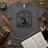 Wicked Witch University Your Magic Awaits t-shirt design featuring a black cat on a broomstick flying past a castle