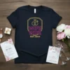 Wife Wife Est. 2024 T-Shirt featuring pink and gold text with wedding rings and a crown graphic