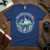 T-shirt with "Wild Frontier Adventures Explore Dream Discover" text and a circular graphic of mountains, trees, and a river