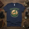 Wild Harvest Hunting Adventures t-shirt featuring a jumping deer and hunting dog graphic with antlers and mountains