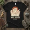 Black t-shirt with "WILD SPIRITS EST. 2024" text and three howling wolves graphic under a red sun