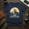 Wilderness Calls Explore The Untamed text on a navy t-shirt with a mountain, deer, and sun graphic