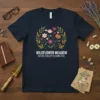 Navy t-shirt with "Wildflower Meadow Nature's Beauty Blooms Free" text and a circular floral graphic