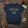 Navy t-shirt with "Will You" text in elegant gold script and interlocking rings graphic for proposal
