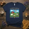 Windy Acres Farm t-shirt design featuring a red barn, sheep, pig, chicken, and sun on a green hill landscape