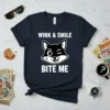 Wink & Smile Bite Me funny cat quote t-shirt with a winking cartoon cat face graphic