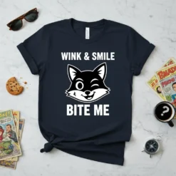 Wink & Smile Bite Me funny cat quote t-shirt with a winking cartoon cat face graphic