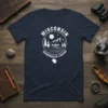 Wisconsin Adirondack Chairs t-shirt design featuring a canoe on a river, mountains, and pine trees in a circular emblem