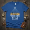 Wise Men Still Seek Him quote with nativity scene graphic on a blue t-shirt