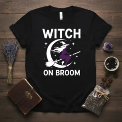 Witch on broom t-shirt design with white text "WITCH ON BROOM" and a purple witch silhouette flying across a crescent