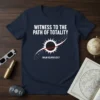 Navy t-shirt with white text "WITNESS TO THE PATH OF TOTALITY SOLAR ECLIPSE 8.21.17" and a graphic of a solar