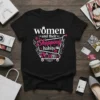 T-shirt with the text "women and their Shopping habits" in white and pink, featuring a shopping cart graphic with bags