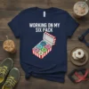 T-shirt with "Working On My Six Pack" text and a box of colorful donuts graphic
