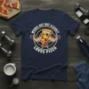 Muscular pizza slice lifting dumbbells with text "Works Out But Clearly Loves Pizza" on a navy blue t-shirt