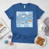 World's Greatest Busha t-shirt with blue floral patchwork, yarn, knitting needles, and cookies graphic
