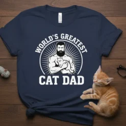 World's Greatest Cat Dad t-shirt featuring a muscular man holding a cat, with text above and below