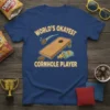 World's Okayest Cornhole Player text with illustration of a cornhole board and bean bags on a blue t-shirt