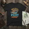 Black t-shirt with "World's Okayest Pilot" text and a vintage airplane graphic