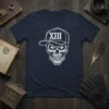 Skull wearing a baseball cap with the Roman numeral XIII on it, printed on a navy blue t-shirt