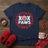 Navy t-shirt with "XOX PAWS" text in white, surrounded by a circular pattern of red paw prints and hearts