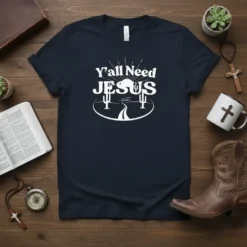 Christian T-Shirt with "Y'all Need JESUS" text, desert landscape, sun, and cacti graphics