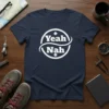 Navy blue t-shirt with white "Yeah Nah" text inside a circular design with arrows, featuring Aussie slang