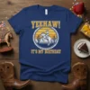 Navy t-shirt with "YEEHAW! IT'S MY BIRTHDAY" text and a cowboy riding a bucking horse graphic, set against a desert