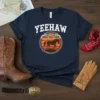 Navy blue t-shirt with "YEEHAW" text, crossed pistols, and a horse silhouette against a sunset graphic