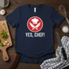 Navy blue t-shirt with "YES, CHEF!" text and a graphic of crossed knives and chef hat within a red circle