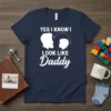 Yes I Know I Look Like Daddy text with silhouette of father and child on a navy blue t-shirt