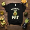 Black t-shirt with "YES, I'M FAT GOOD FAT" text and a smiling avocado wearing sunglasses graphic